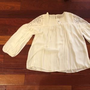 White blouse with lace shoulder detail